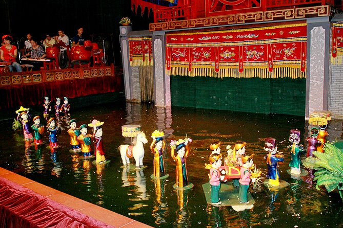 Saigon Evening: Water Puppet Show & Dinner Cruise Experience - Golden Dragon Theater: wooden figures on a watery stage